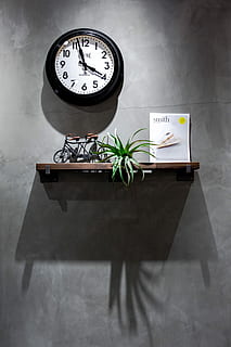 black and white analog wall clock displaying 3:58, round black and white analog wall clock near brown wooden floating shelf HD wallpaper