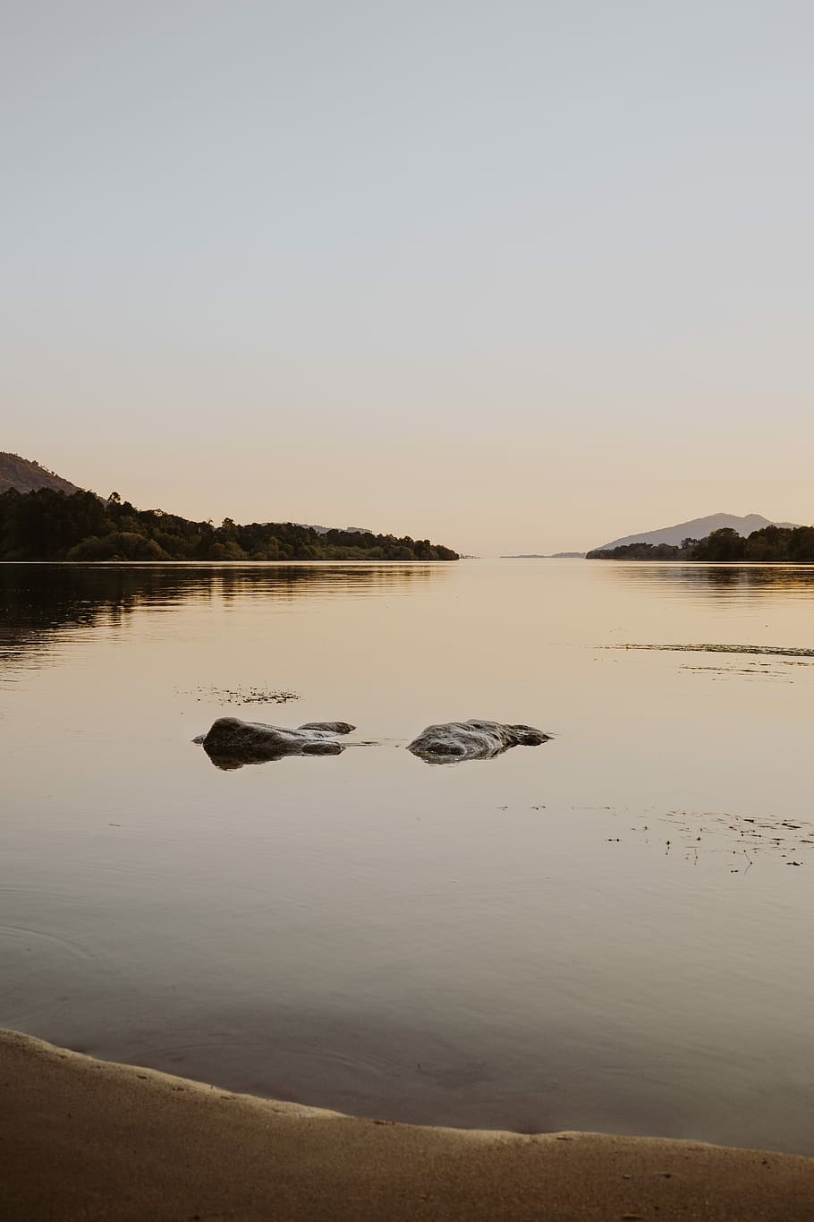 bodies of water near stone at daytime, rocks on body of water surrounded with mountain HD wallpaper