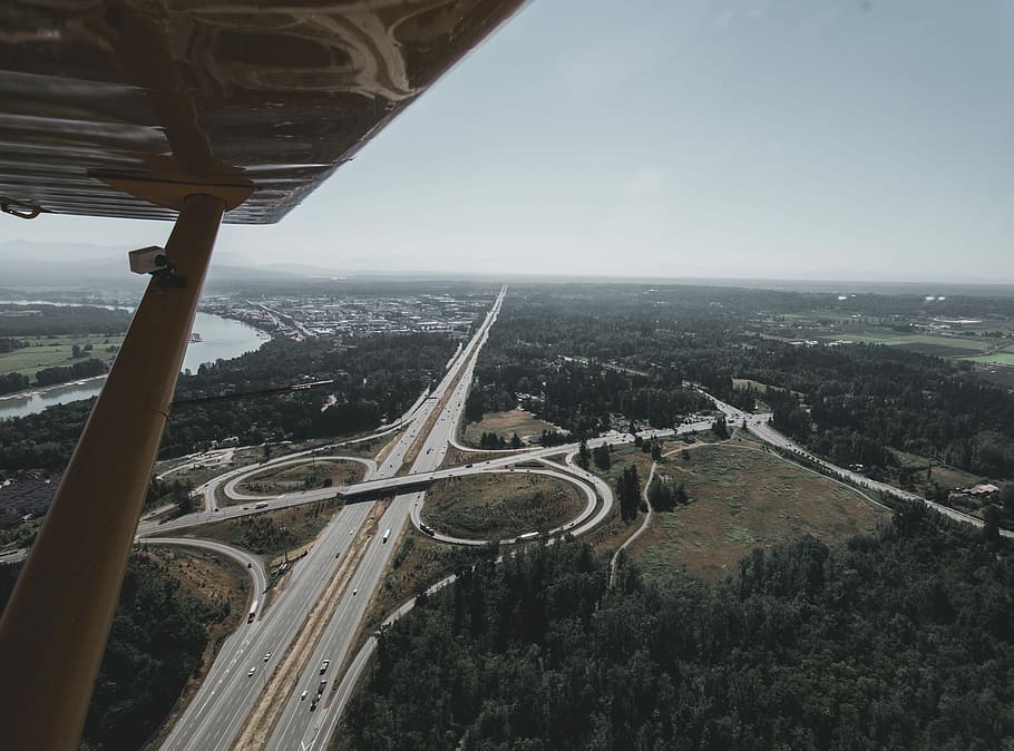 aerial photography of roads, aerial photography of road and river under gray sky HD wallpaper