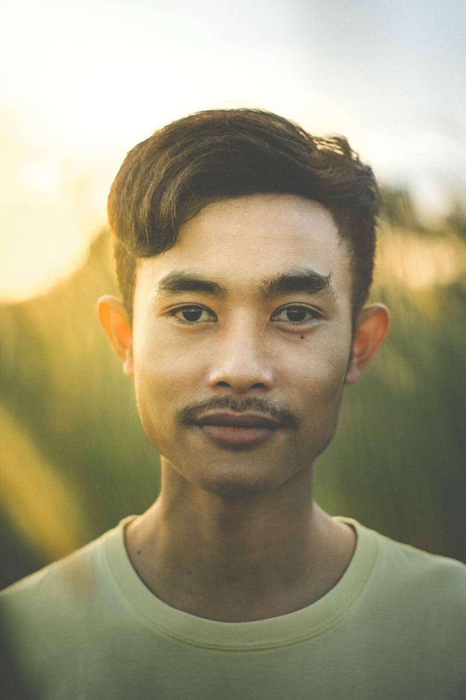 shallow focus photography of man in yellow crew-neck shirt, close up photography of man wearing yellow crew-neck shirt looking straight HD wallpaper