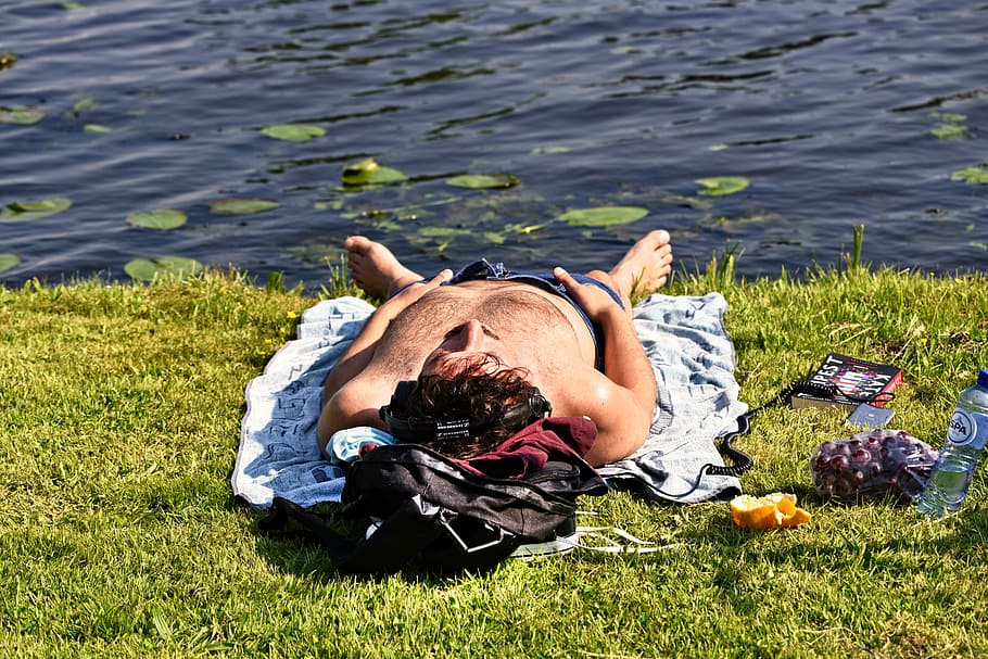 man lying on grass near lake, person, lying down, sunbathing HD wallpaper