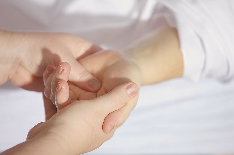 person holding baby's hand, treatment, finger, keep, wrist, hand massage