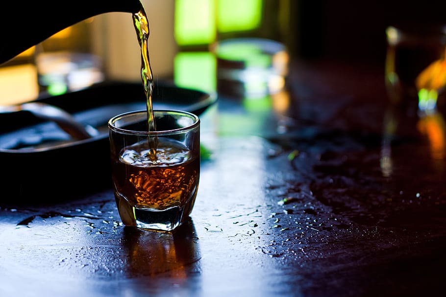 beverage container pouring liquid on shot glass, tea, drink HD wallpaper