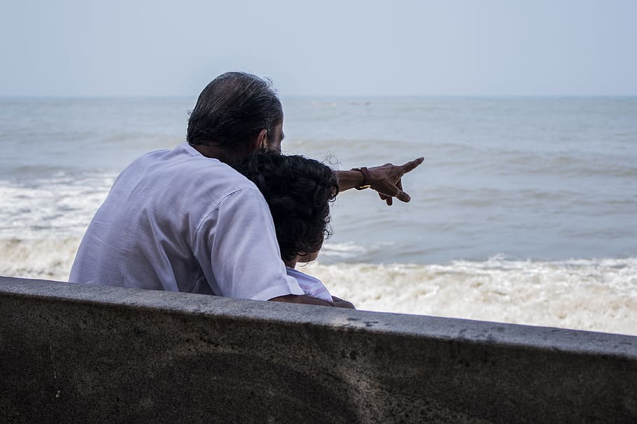 man pointing at body of water during daytime, Grandfather, Granddaughter