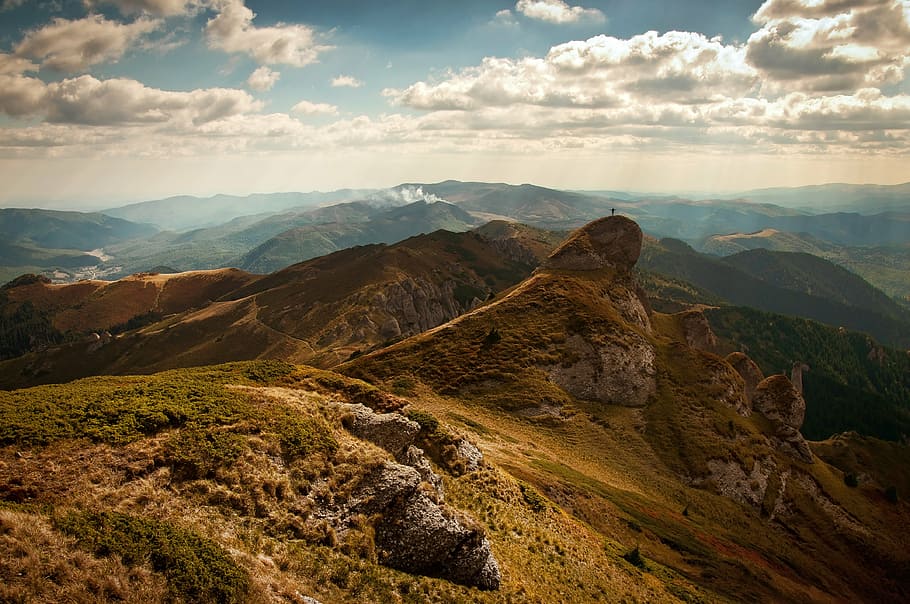 brown rock mountain during daytime, person, top, sky, clouds HD wallpaper