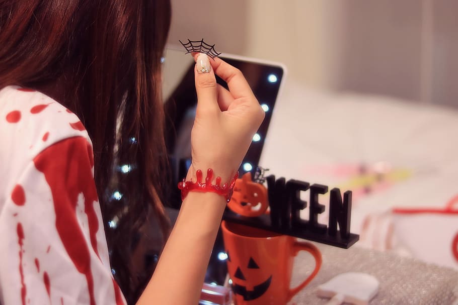 woman in front of mirror holding halloween decor, women, one Person HD wallpaper