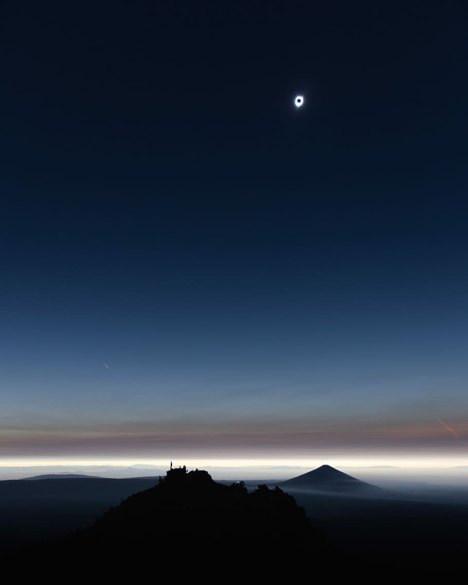 silhouette of castle during lunar eclipse, top view of mountain covered by clouds HD wallpaper
