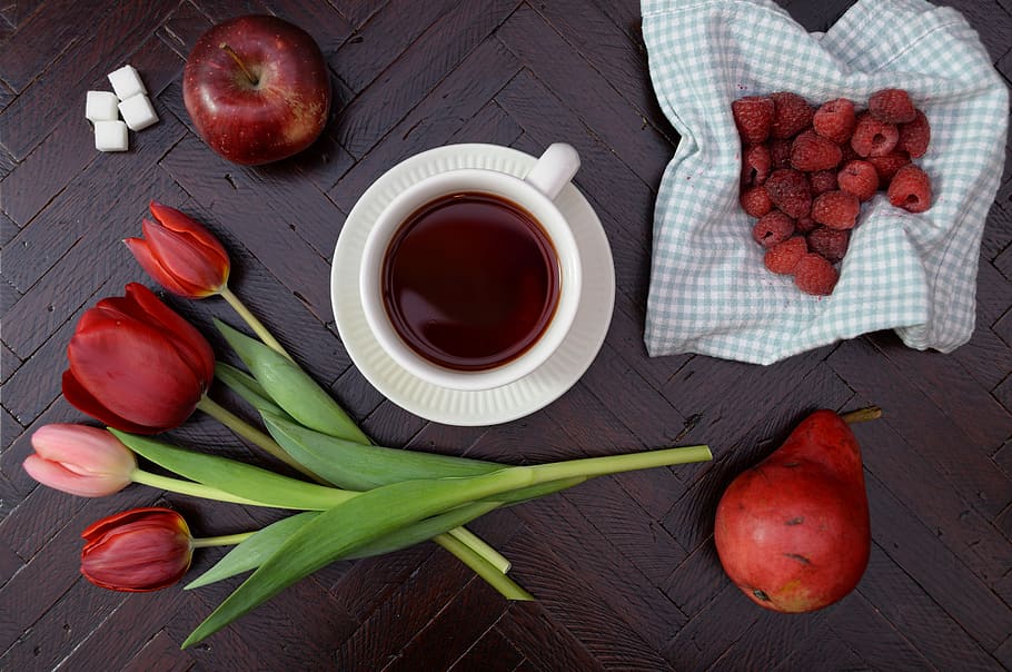 teacup on saucer near apple and tulip flower, red flowers beside cup of tea HD wallpaper