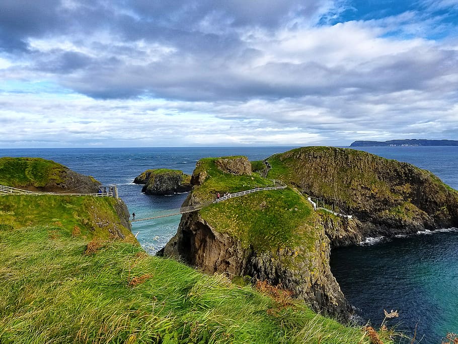 mountains near ocean, green island, cliff side, grass, clouds HD wallpaper