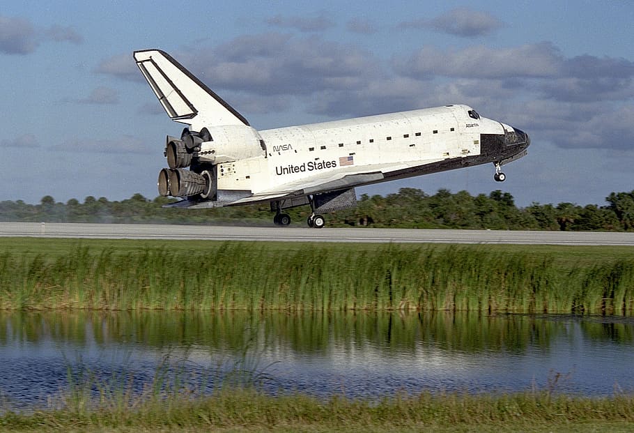 United States space shuttle near lake, atlantis, landing, runway