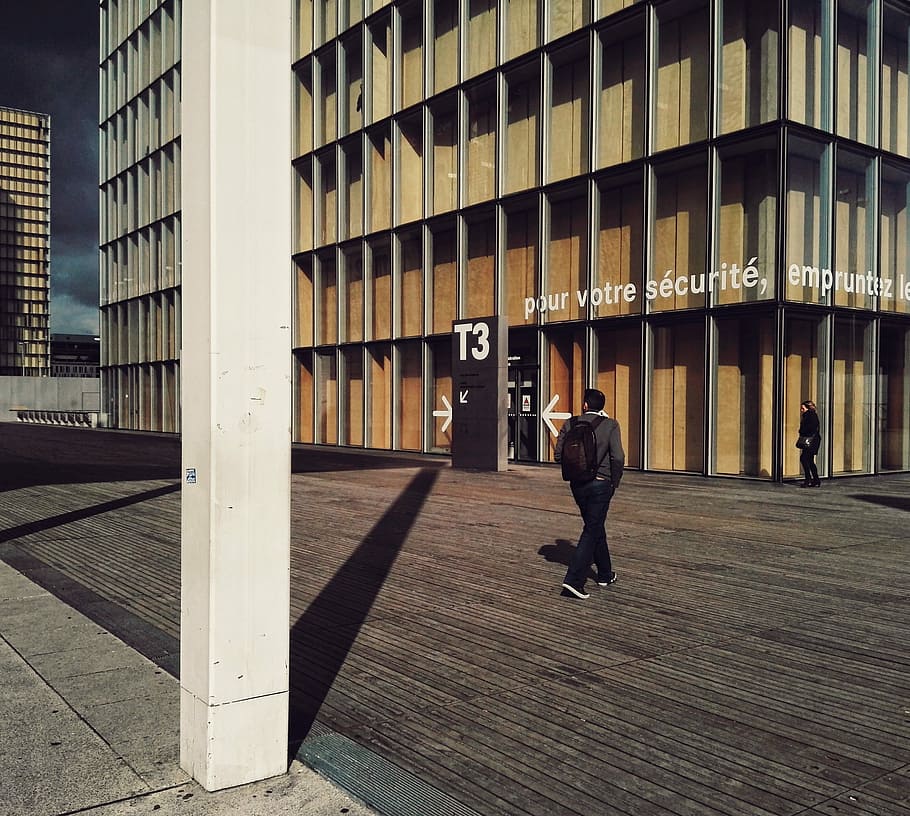 Bibliothèque nationale de France, man walking in front of concrete building, HD wallpaper