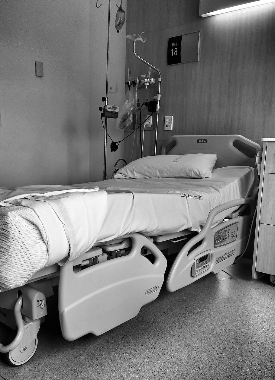 grayscale photography of hospital bed beside cabinet, emergency