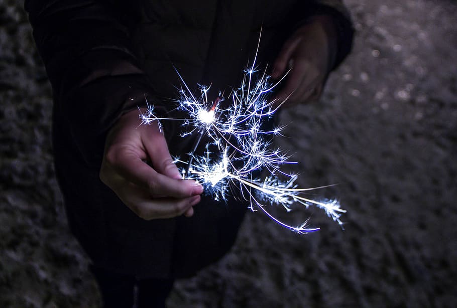 person holding sparkler, person holding firecracker, firework HD wallpaper