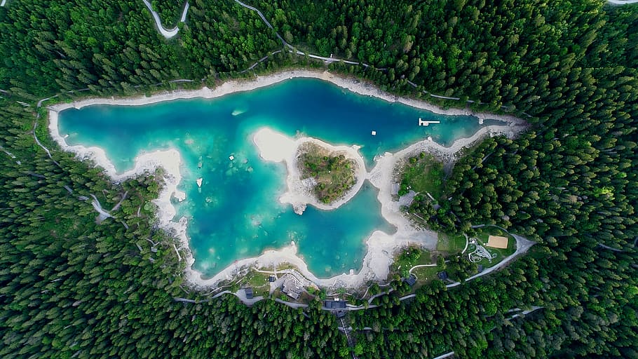 aerial photography of body of water surrounded by trees at daytime, areal photography of body of water surrounded by trees