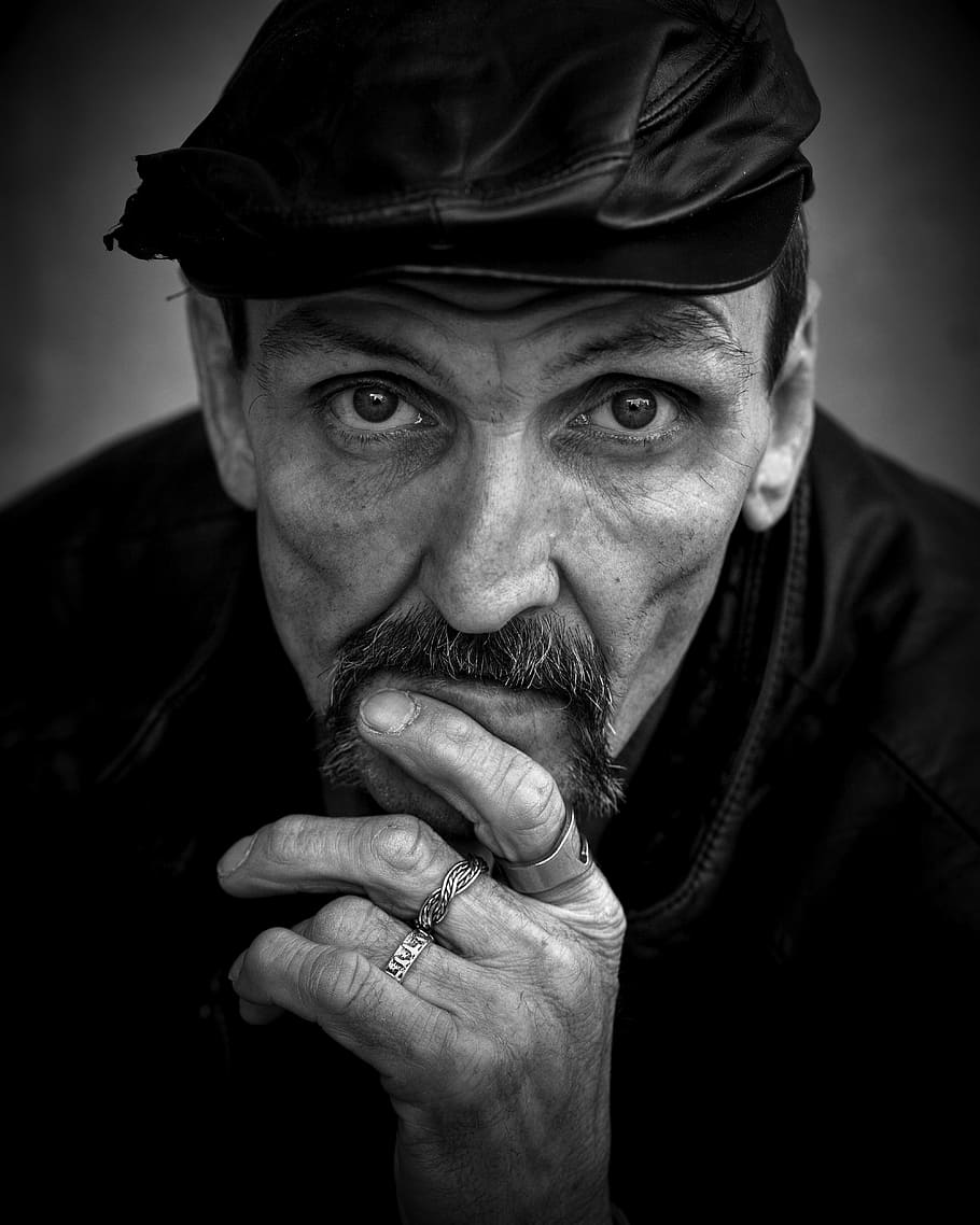 grayscale photo of man with leather flat cap, homeless, male