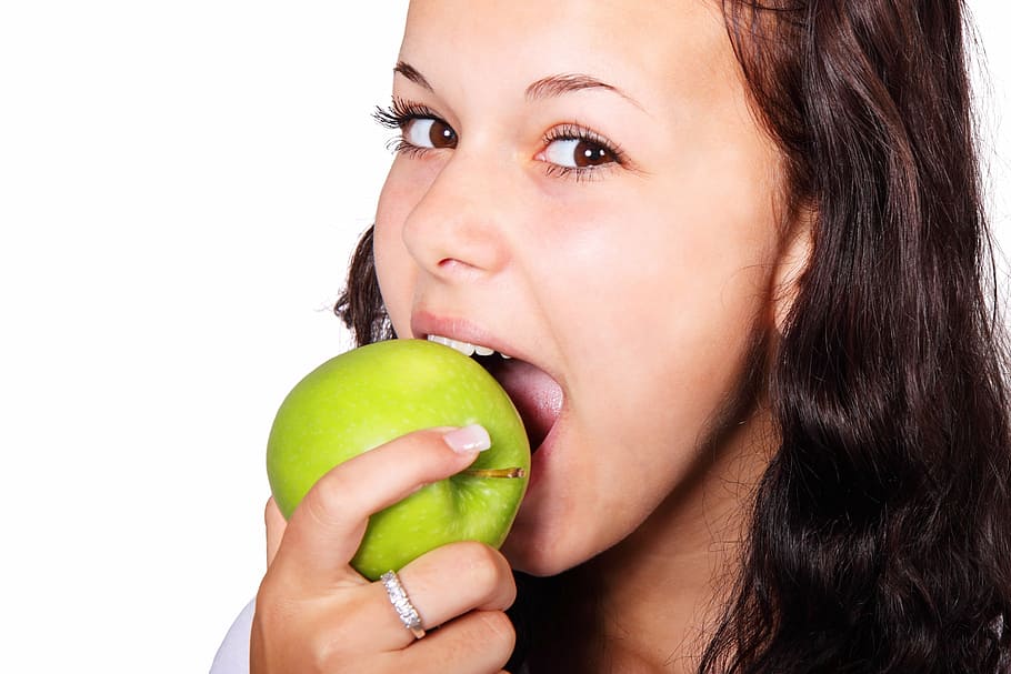 woman with silver-colored ring holding green apple, bite, diet HD wallpaper