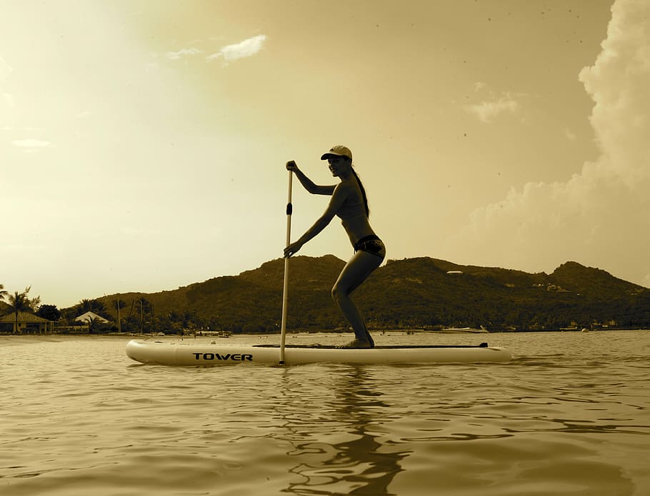 woman surfing using paddle, st barts, sunset, sup, girl, rowing