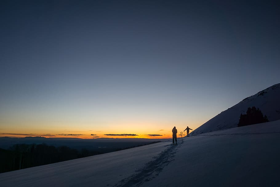 person standing on snowfield during daytime, person walking at shore during goldenhour HD wallpaper