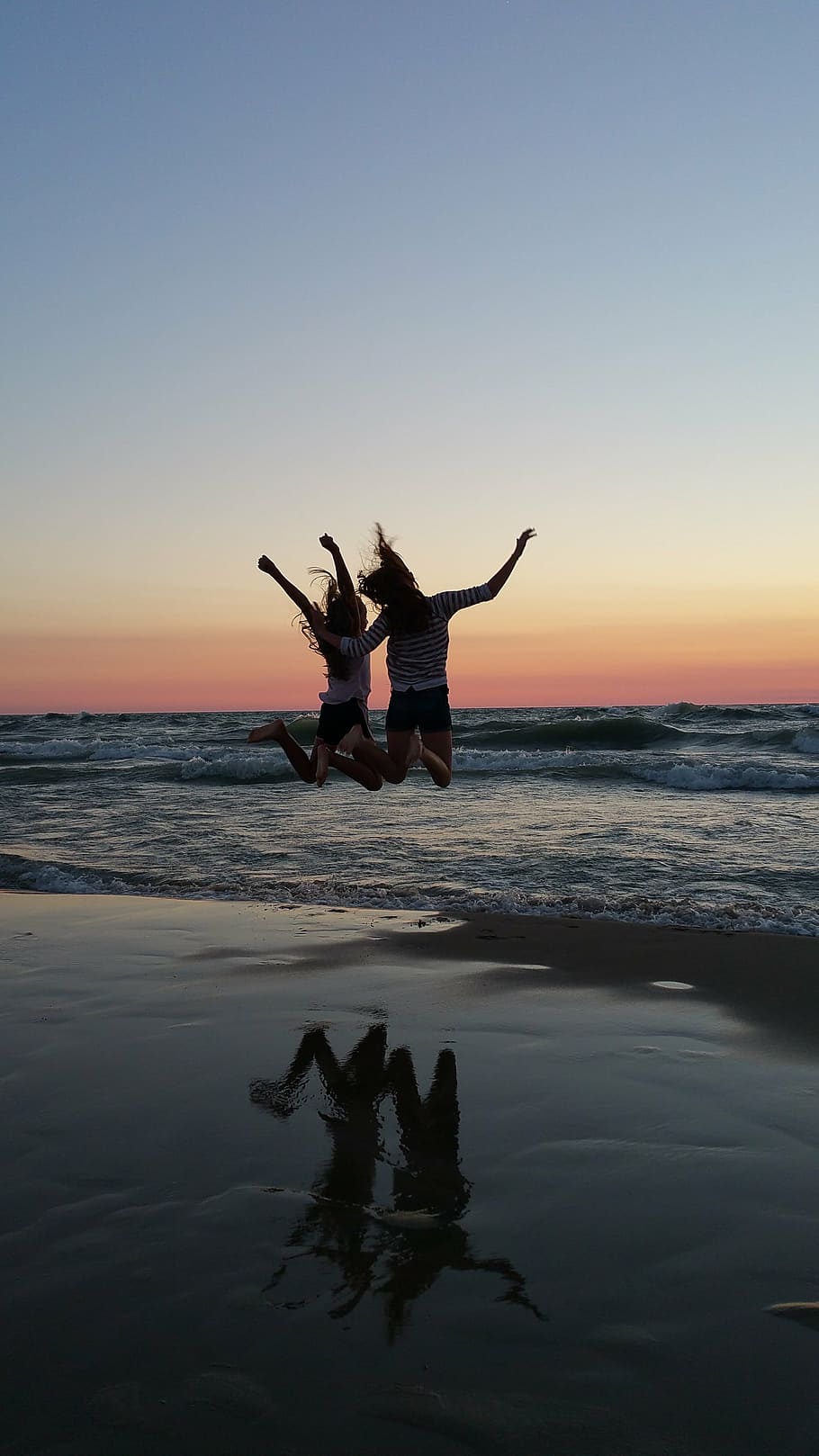 two women jumping on seashore, best friends, sunset, beach, cheer, HD wallpaper