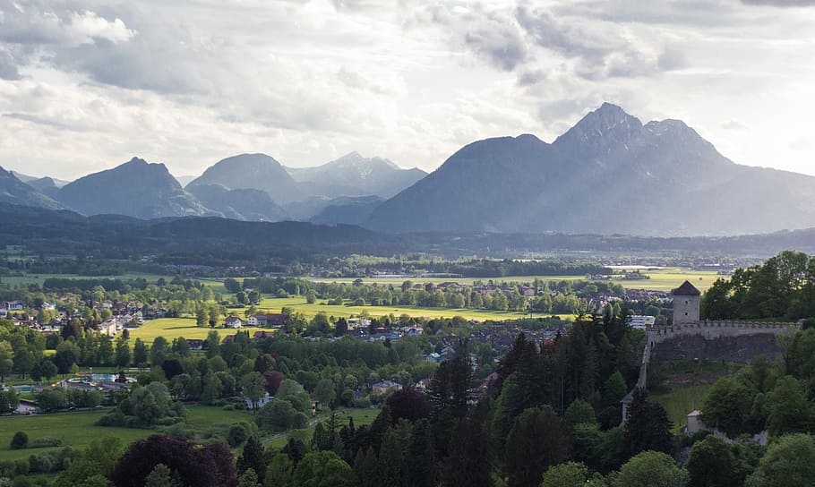 aerial view of green land and mountain, mountains near trees under white clouds