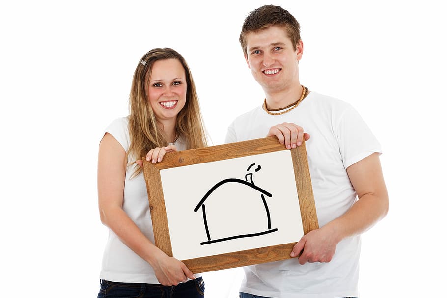 man and woman holding board with house sketch, home, couple, mortgage
