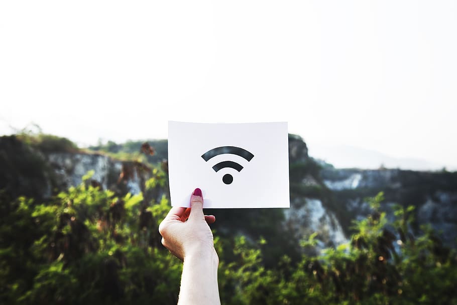 person holding Wi-Fi printed paper, person holding wifi signal icon