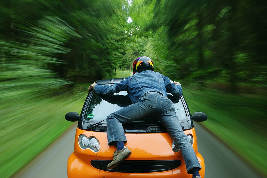 person on orange car, smart, auto, speed, traffic, vehicles HD wallpaper