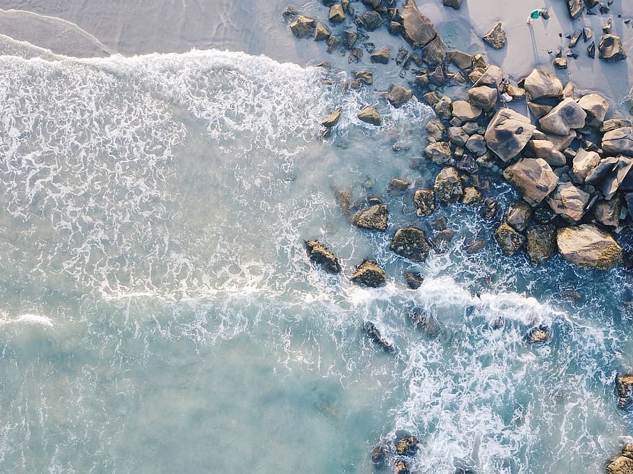 aerial photography of beach with stones, gray stone on seashore HD wallpaper