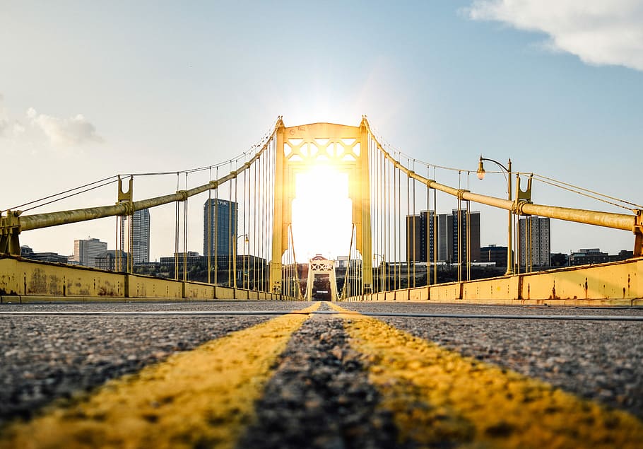 worm's eye view photography of bridge, gray and brown suspension bridge under blue sky and white clouds during daytime HD wallpaper