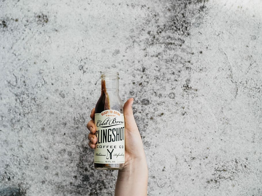 person holding Slinghot coffee bottle, person holding Cold Beer glass bottle HD wallpaper
