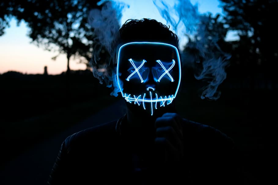man wearing LED mask, neon light mask on person's face, faceless
