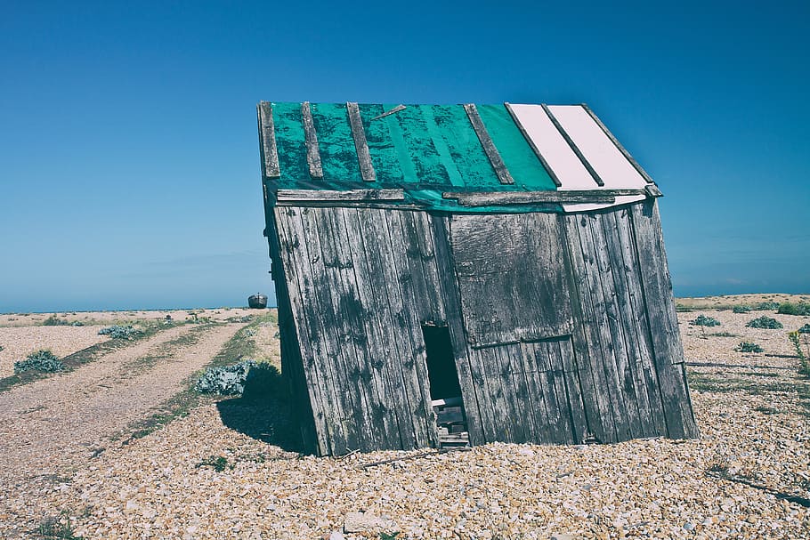 Shot of an old abandoned shack that has started to subside. Image captured in Dungeness, Kent, England HD wallpaper
