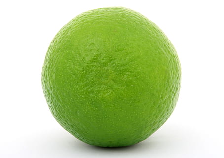 selective focus photography of green lime on white surface HD wallpaper