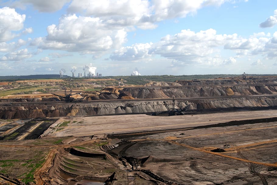 brown and gray field under white clouds and blue sky, brown coal mining
