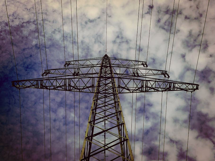low-angle photography of grey metal electricity tower under cloudy skies HD wallpaper