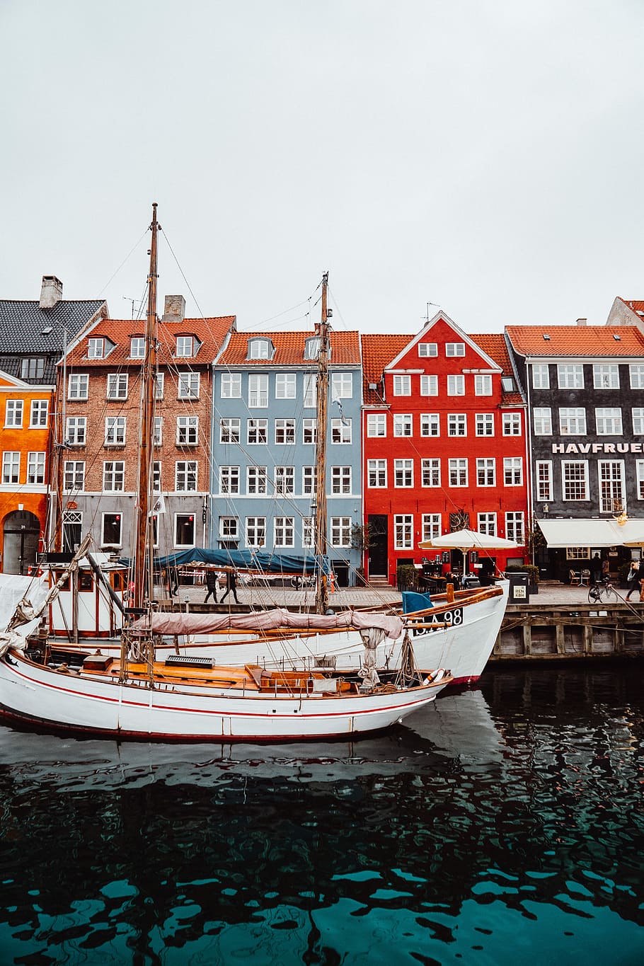 white boat on body of water during daytime, photo of two white boat near the five assorted-color 5-storey buldings HD wallpaper