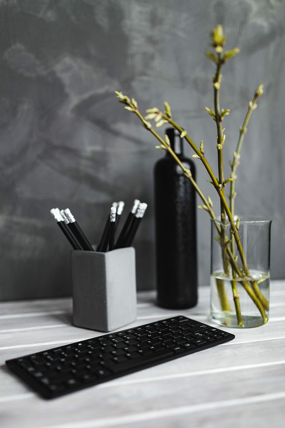 Black keyboard with pencils on a white table, bottle, plant, desk HD wallpaper