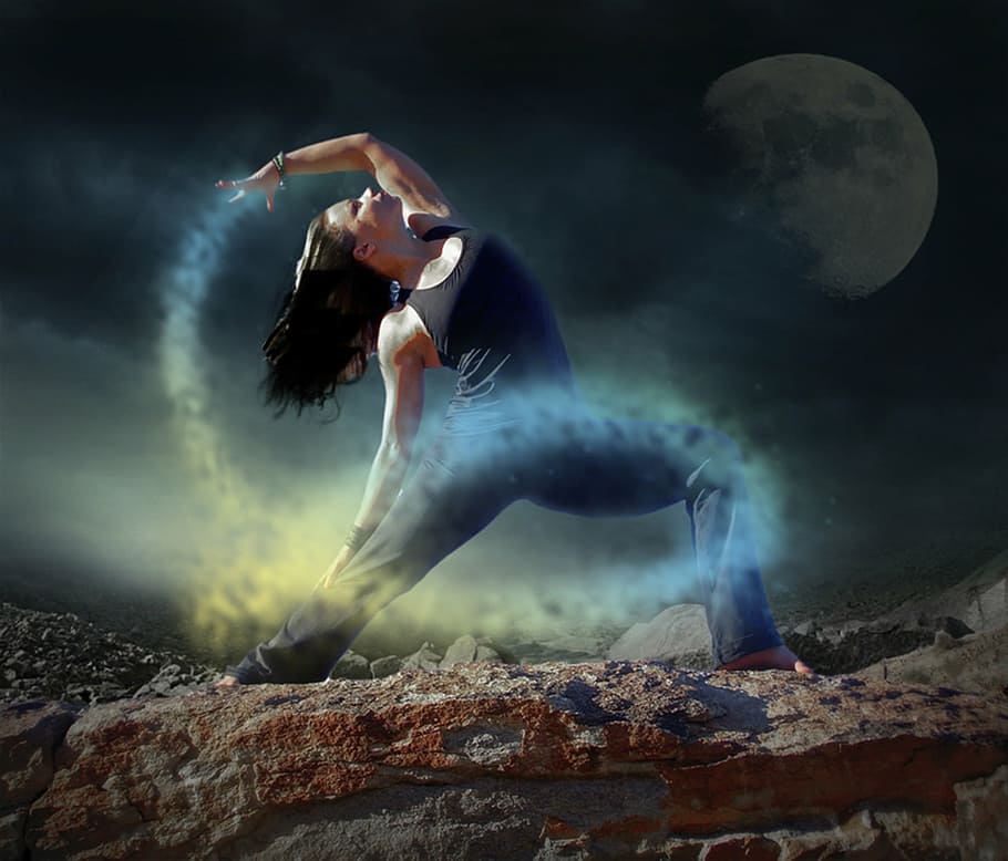 woman wearing black tank top and pants during night time, yoga