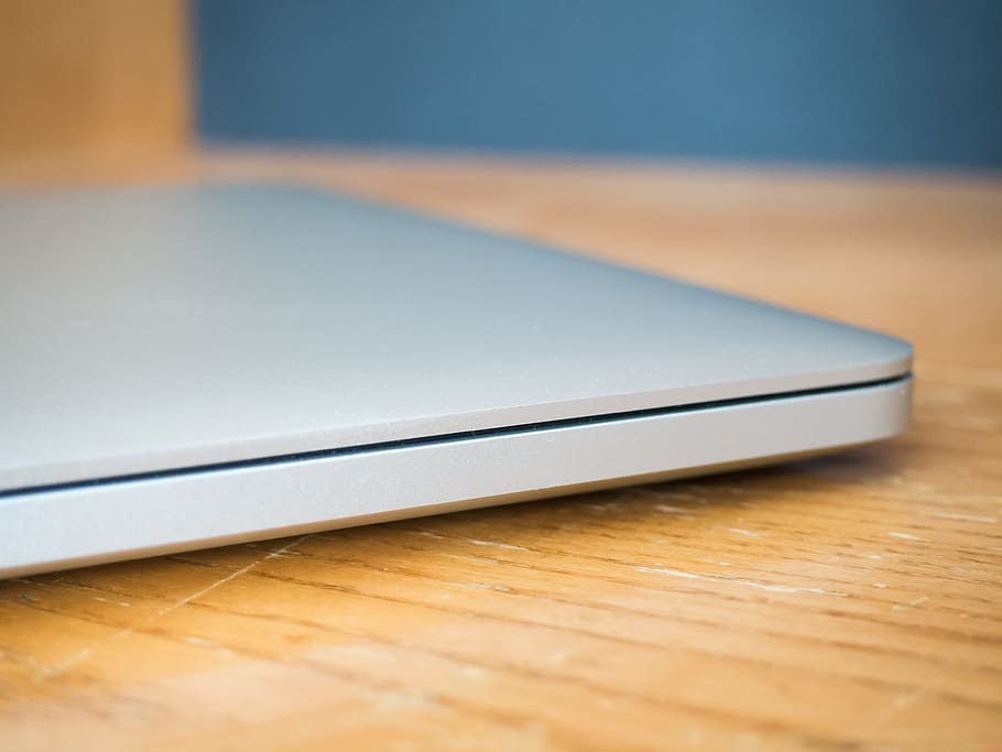 Closed Laptop on Wooden Desk, computer, metal, work, Business HD wallpaper
