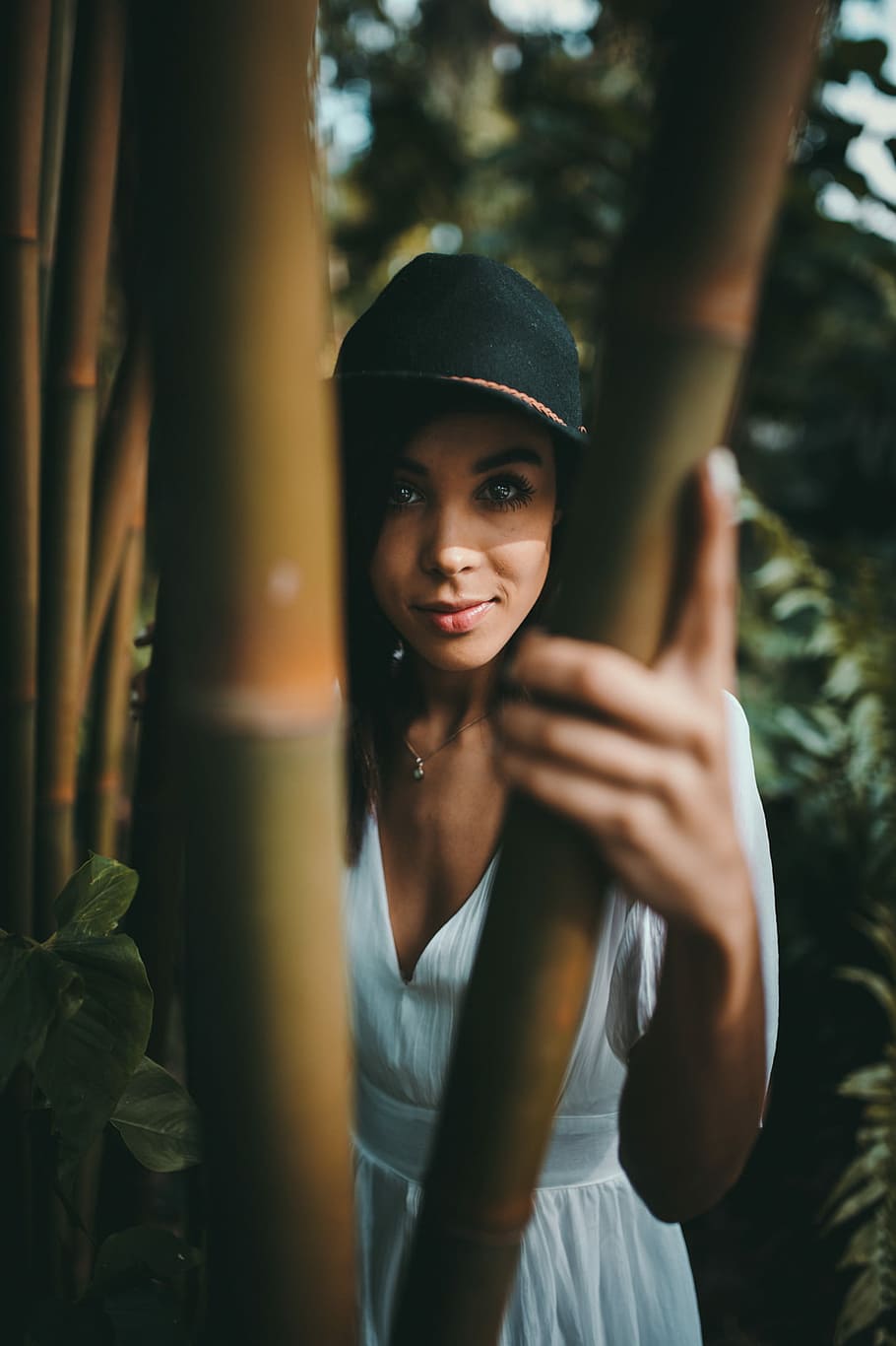 standing woman wearing white dress holding bamboo, woman hiding on bamboo trees HD wallpaper
