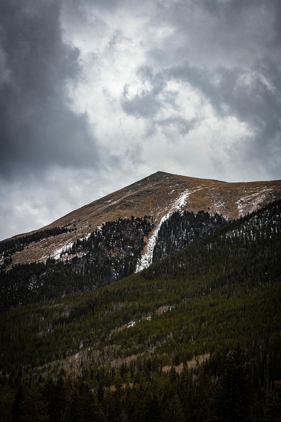 bird's eye view photography of mountains under nimbus clouds, low-angle photo of mountains under thick gray clouds HD wallpaper