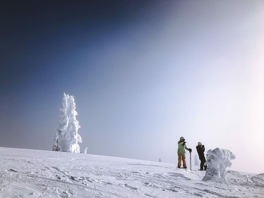 two people standing on mountain covered with snow, two person walking on snow covered mountain HD wallpaper