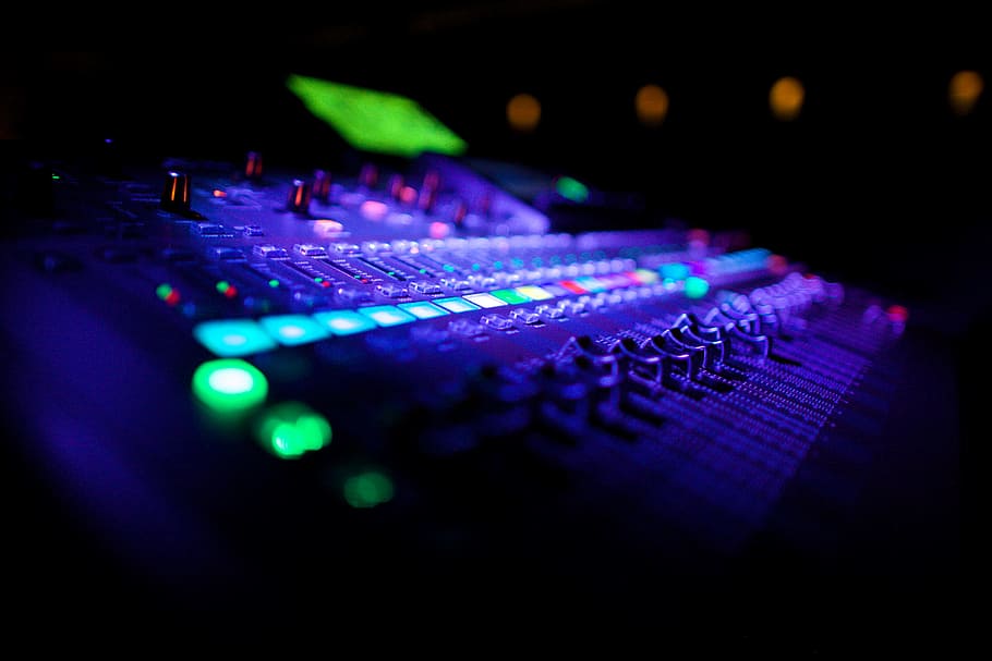 Closeup shot of audio music mixing equipment, technology, illuminated