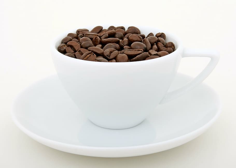 coffee beans on white ceramic coffee cup and saucer, aroma, background