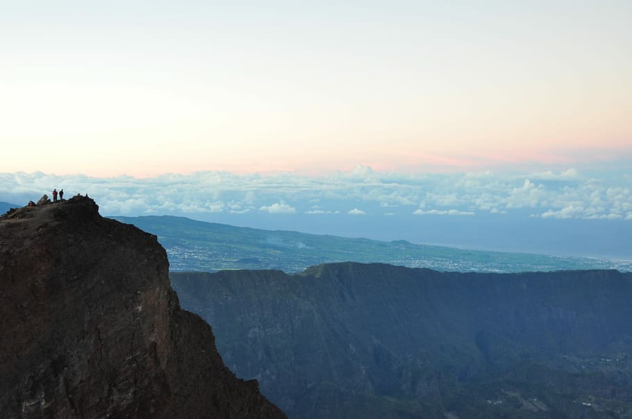person standing on cliff during daytime, two persons standing on cliff HD wallpaper