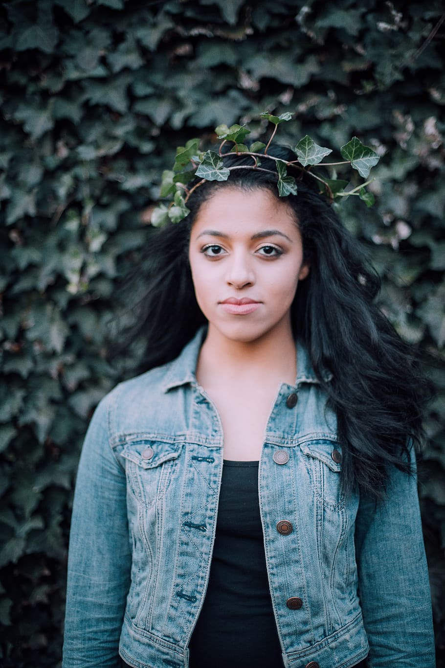 Young cute woman in a denim jacket and with a backpack posing on a white  background 6589927 Stock Photo at Vecteezy