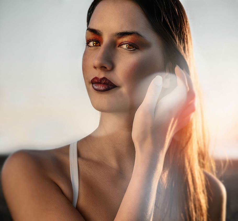 woman's face holding her hair during daytime, closeup photo of woman holding her hair HD wallpaper