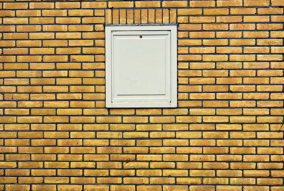 closed white door on brown wall, brick wall, yellow brick wall