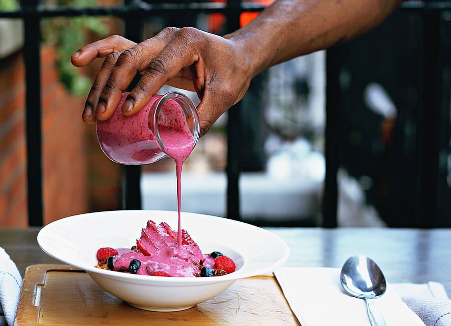 person pouring strawberry syrup on mixed berry fruit, people HD wallpaper