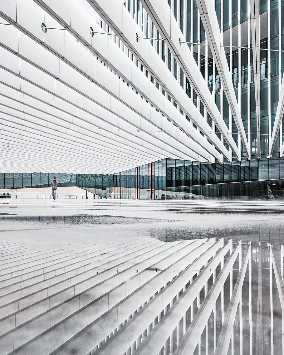 Crazy white architecture, person in grey long-sleeved shirt walking near curtain building HD wallpaper